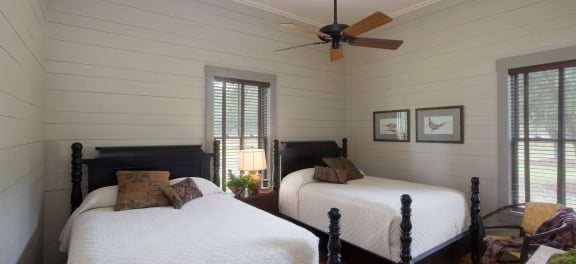 A cozy bedroom in Broadfield Lodge featuring two double beds.