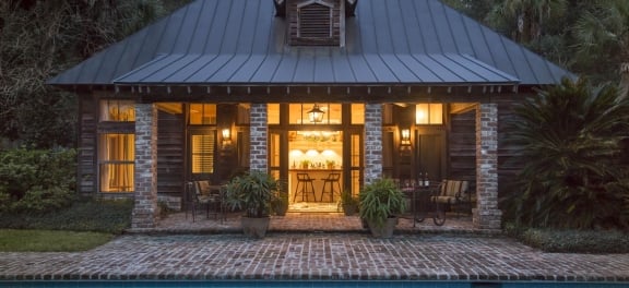 The Broadfield Lodge Pool House, a large modern cabin with brick terrace and in-ground pool.