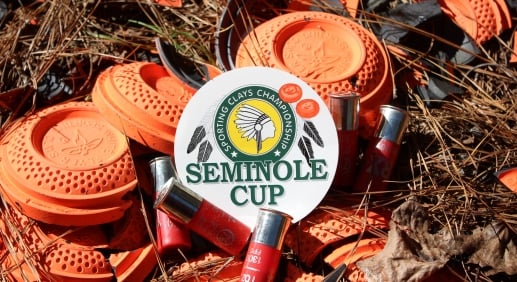 The seminole Cup artfully placed among bright orange sporting clays on the forest ground in the sunshine.