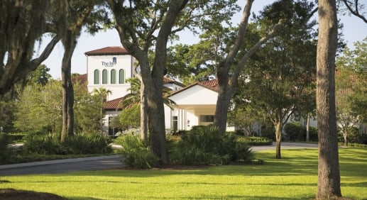 The exterior of The Inn at Sea Island, a great while building with terracotta roof tiles.