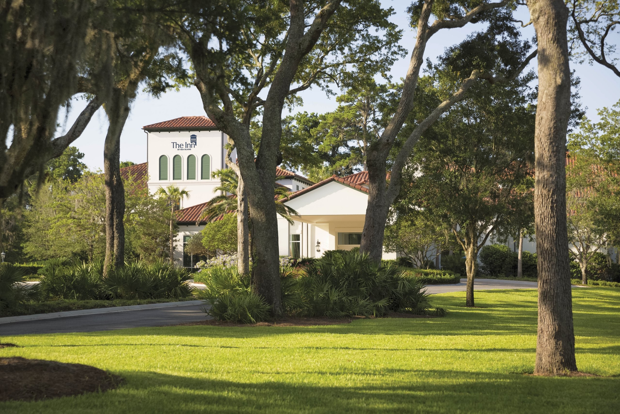 The exterior of The Inn at Sea Island, a great while building with terracotta roof tiles.